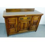 An oak ledgeback sideboard, the rectangular top with moulded edge over a central drawer flanked by