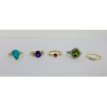 A collection of five 9 carat gold gemset dress rings to include a three stone diamond ring, all UK