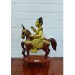 A gilt wood Eastern horse and rider figure group on oval base, 45cm high
