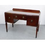 A mahogany ledgeback sideboard of small proportions, a central long drawer flanked by deeper