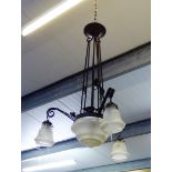 A black iron and opaque glass chandelier / ceiling light with a central domed shade and three