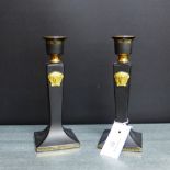 A pair of Versace Gorgona patterned black glazed and gilt highlighted candlesticks for Rosenthal,