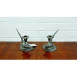 A pair of pewter candlesticks on octagonal bases surmounted by pheasant's (2)