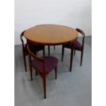 A mid century Danish teak dining set by Frem Rojle comprising circular table and set of four