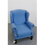 A blue upholstered wing armchair on straight supports 104 x 82cm