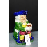 A Copeland Spode Toby jug depicting a seated tavern drinker in green frock coat, blue tricorn hat