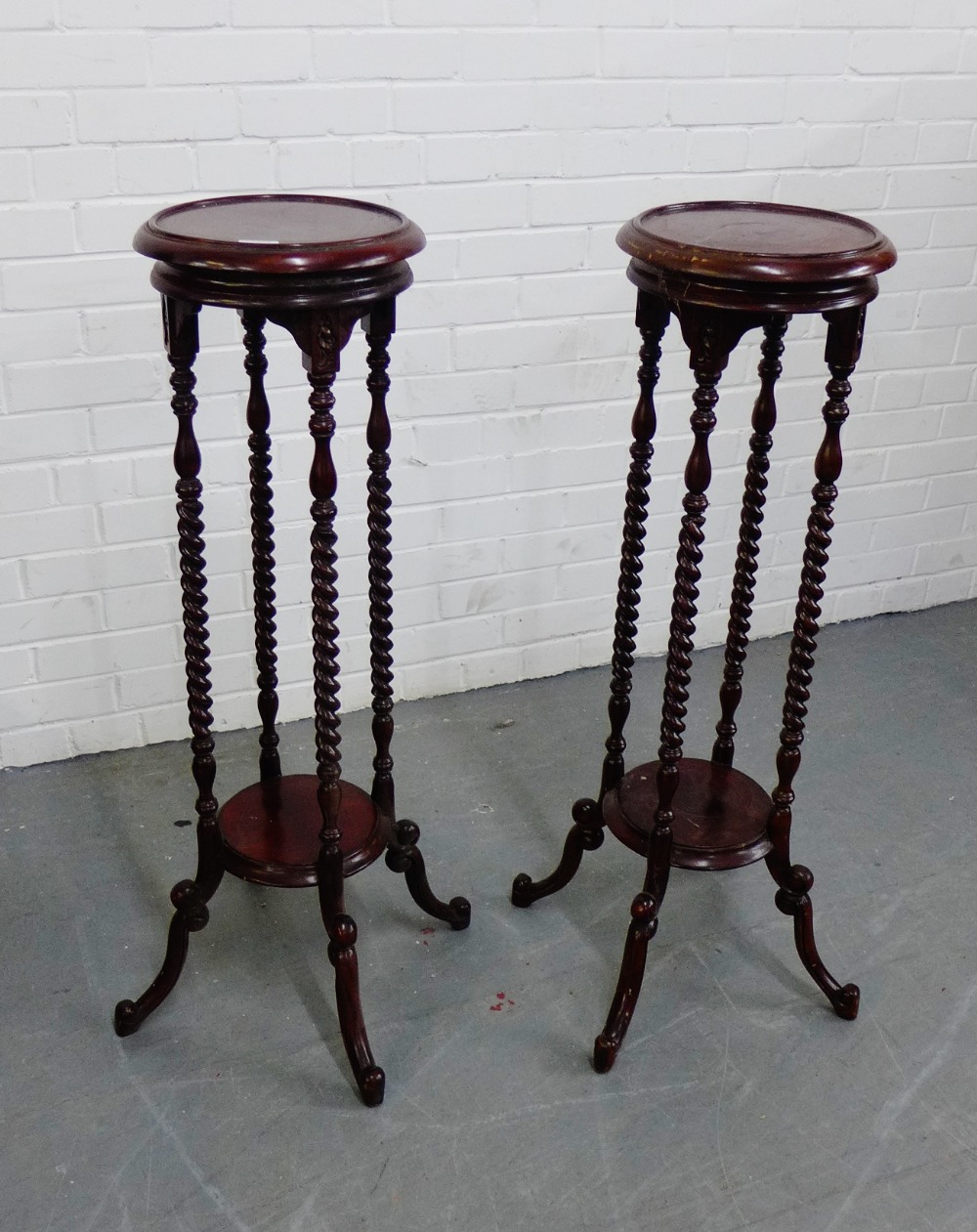 A pair of mahogany plant stands, the circular tops on barley twist supports, 100 x 30cm, (2)