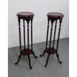 A pair of mahogany plant stands, the circular tops on barley twist supports, 100 x 30cm, (2)