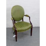 A mahogany framed open armchair with upholstered back, arms and seat, raised on tapering supports,