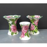 A pair of Wemyss frilled rim vases painted in cabbage roses, together with another smaller (