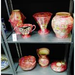 A collection of Kensington Price pink lustre glazed pottery to include vases, posies and a bowl