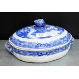 A Chinese blue and white tureen and cover painted with a willow pattern, the lid with an acorn
