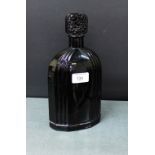 An Art Deco black glass cologne / perfume bottle with stylised floral moulded stopper, 26cm high