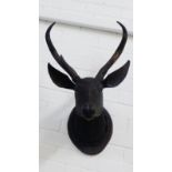 A carved wood Deer's head