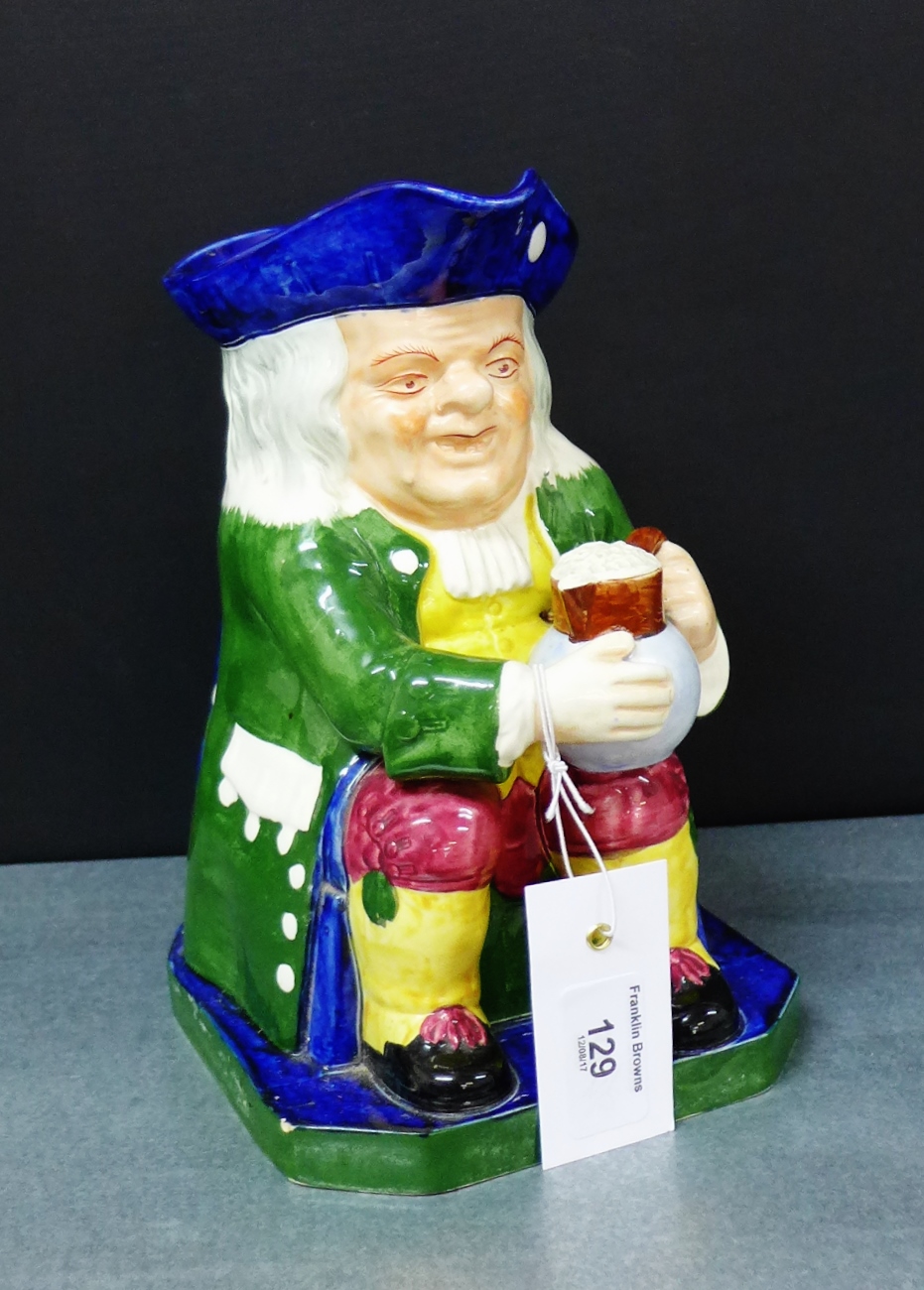 A Copeland Spode Toby jug depicting a seated tavern drinker in green frock coat, blue tricorn hat