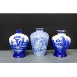 Two Royal Doulton blue and white high shouldered baluster vases painted with a rural scene, together