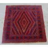 A tribal Gazak rug, the red field with geometric pattern and flowerhead border, 118 x 118cm