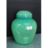 A Monart green glass ginger jar and cover, remnants of paper label to base, approx 26.5.cm