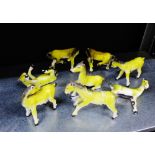A collection of eight yellow glazed Chinese pottery horses, 9cm high, (8)