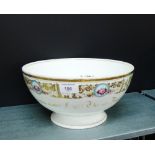 A porcelain bowl, the white ground with gilt edge and borders with blue floral panels with