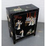 A Chinese black lacquered two door cabinet with figures in a garden pattern, 76 x 60cm