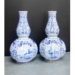 A pair of Delft double gourd shaped bottle necked vases painted with Windmill and landscape panels