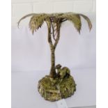 An Epns centre table centre piece modelled as a palm tree with a hound at the base, 36cm high