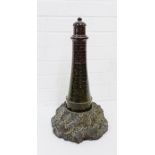 A granite Lighthouse on a rocky base, height overall 48cm