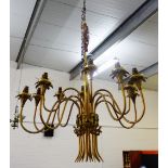 A brass twelve branch light fitting with ribbon mounts, drop approx 85cm