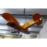 A model bi-plane painted in yellow and silver with wooden body and painted paper wings, 95 x 95cm