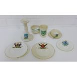 A collection of Goss crested ware to include a candlestick, beaker, cup, saucer and bowl, together