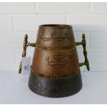 A Tavern twin handled tankard with copper hand beaten mounts, 23cm high