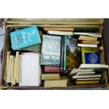 A cabin trunk with vintage travel labels to the exterior, containing a quantity of vintage books