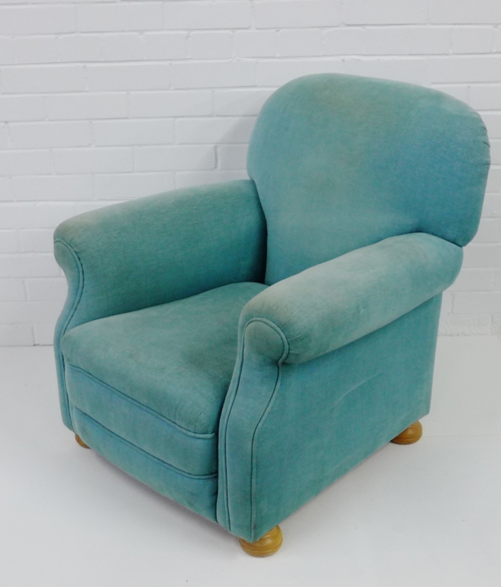 A contemporary pale green upholstered armchair, on beechwood bun feet