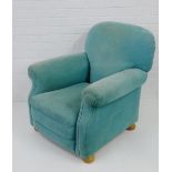 A contemporary pale green upholstered armchair, on beechwood bun feet