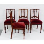 A set of four mahogany framed chairs, with carved top rail and vertical splat backs over red