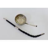 A coin set punch ladle, unmarked, and a white metal mounted twisted whale bone handle (a/f)