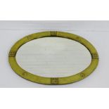 An Arts & Crafts brass framed oval mirror, 70 x 50cm