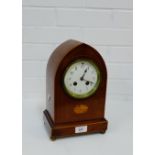 A mahogany and satin inlaid mantle clock, the enamel dial with Arabic numerals and an inlaid paterae