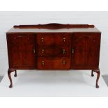 A mahogany ledgeback sideboard, with three central drawers flanked by cupboard doors and raised on