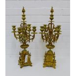 A pair of late 19th century gilt metal four branch candelabra, each with a detachable rose finial on