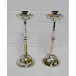 A pair of WMF silver plated candlesticks with a tapering knop stemmed support and a dished sconce on