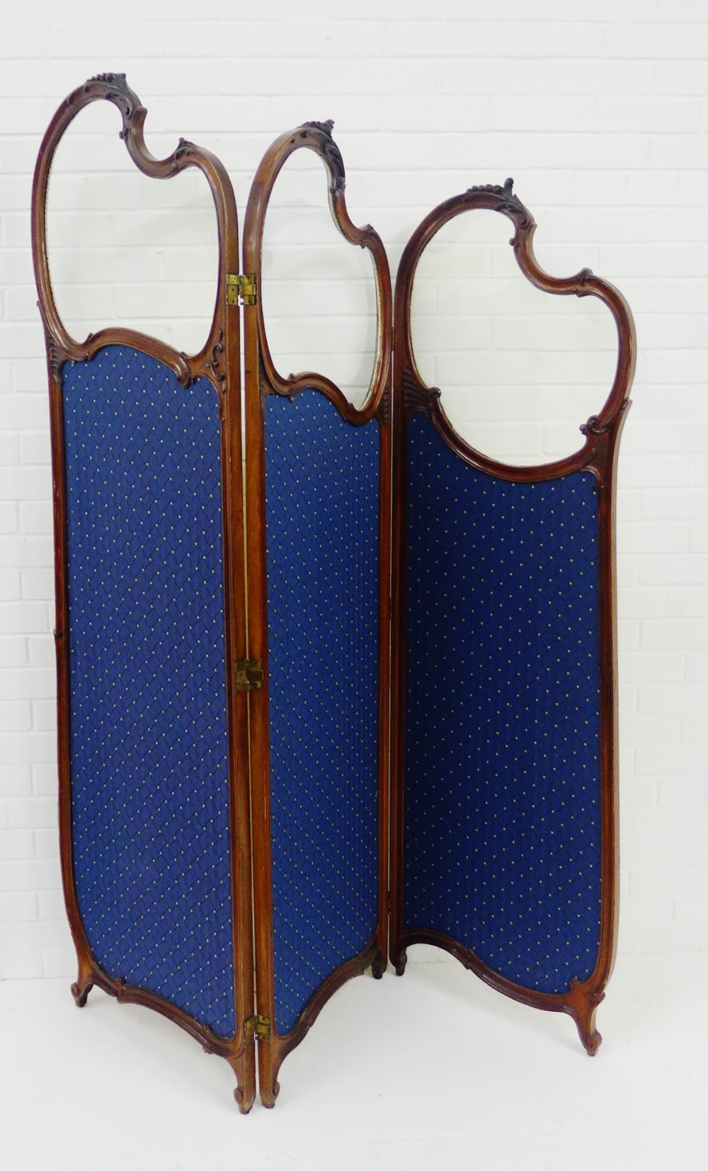 A Victorian mahogany framed three fold draught screen, one view with blue upholstered panels and