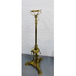 A brass standard lamp on tripod base with hairy paw feet, 135cm high