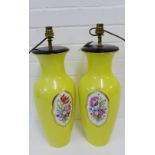 A pair of Berlin porcelain table lamps of baluster form, the yellow ground with mixed flower bouquet