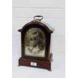 A 19th century mahogany cased bracket clock, the arched top over a silvered dial with Roman numerals