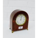 A mahogany and inlaid domed top mantle clock on brass feet, 18cm high