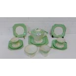 A Palissy Art Deco tea set comprising five cups, four saucers, six side plates, cake plate, milk