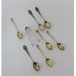 A collection of seven various Sheffield silver teaspoons and a pair of Sheffield silver sugar