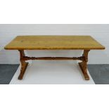 A pine table on shaped side supports and turned undertier, 78 x 182cm